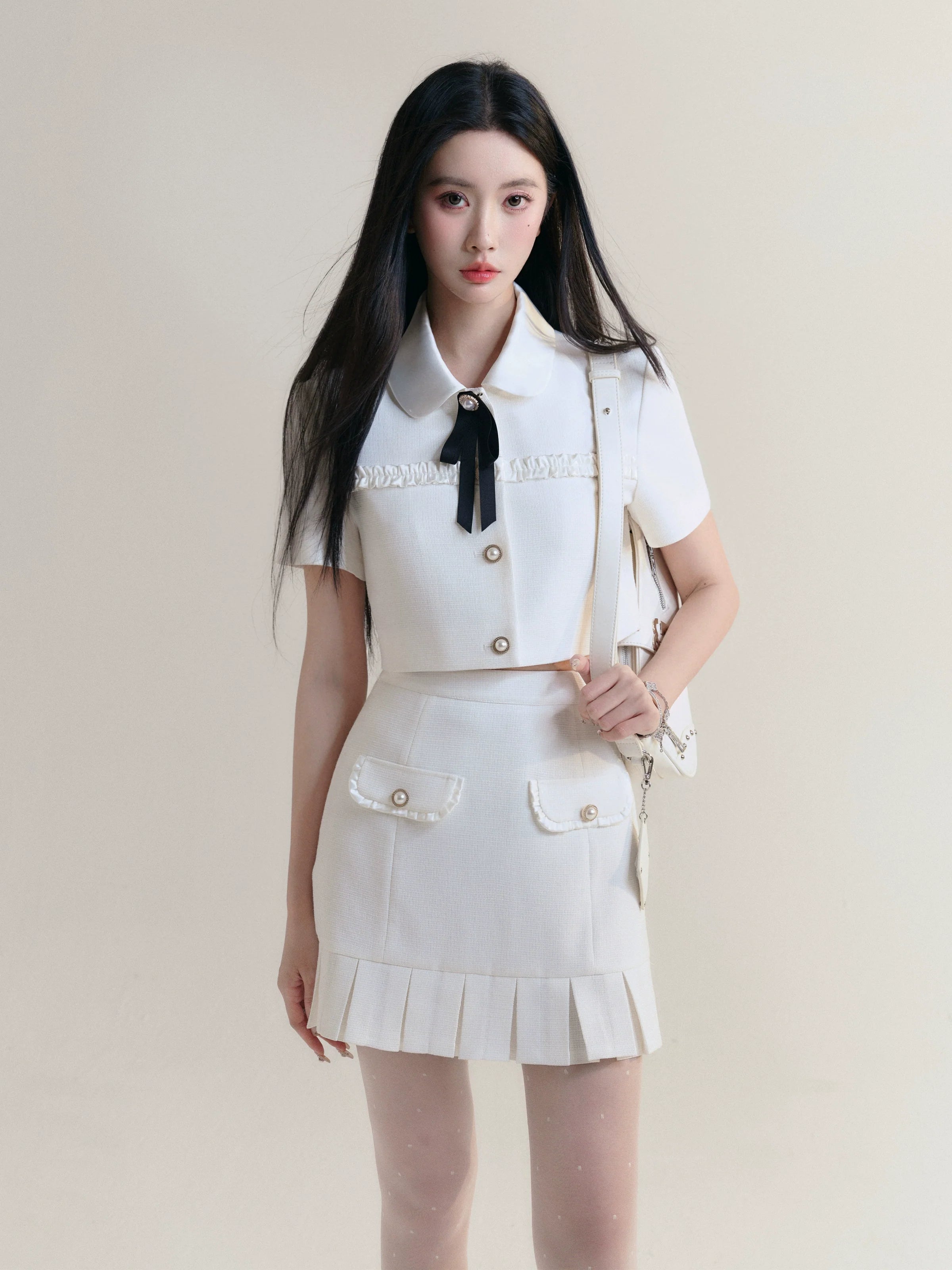 Ivory Elegance Bow-Tie Crop Blouse and Pleated Mini Skirt Set